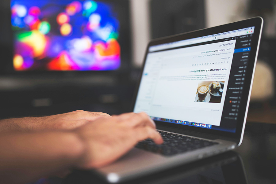 man writing post on a laptop